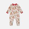 Beige one‑piece organic cotton pajama with girly reindeer print, featuring long sleeves, asymmetrical zipper, and soft interlock fabric.