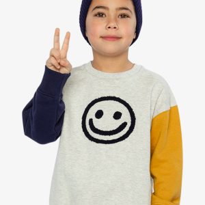 Deux par Deux fleece sweatshirt in heather grey with yellow and blue colorblock raglan sleeves and smiley face graphic